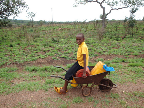 Young boy carrying water home.